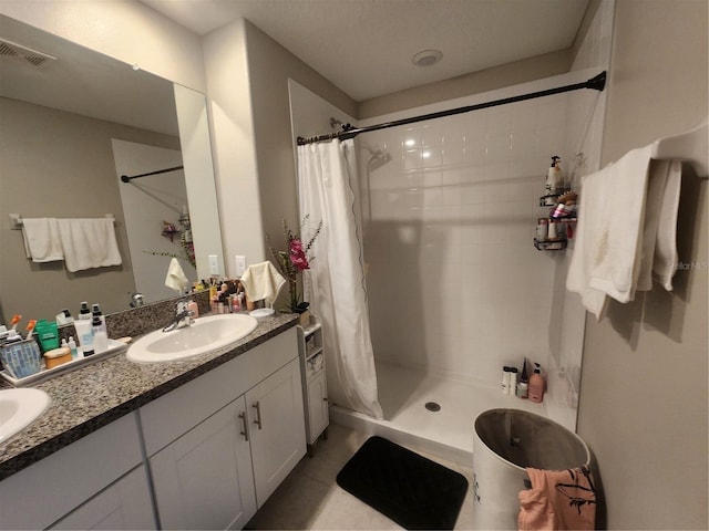 16725 Delia St, Wimauma, FL 33598 - full bathroom with double vanity, a stall shower, and tile patterned floors