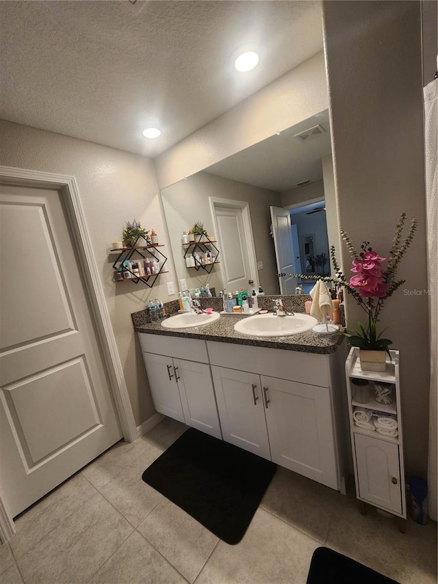 16725 Delia St, Wimauma, FL 33598 - full bath featuring double vanity, tile patterned floors, and a textured ceiling