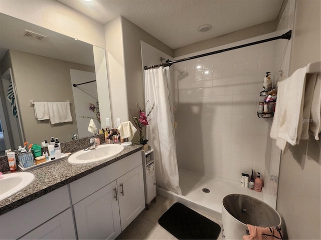 16725 Delia St, Wimauma, FL 33598 - bathroom featuring double vanity, a tile shower, and tile patterned flooring