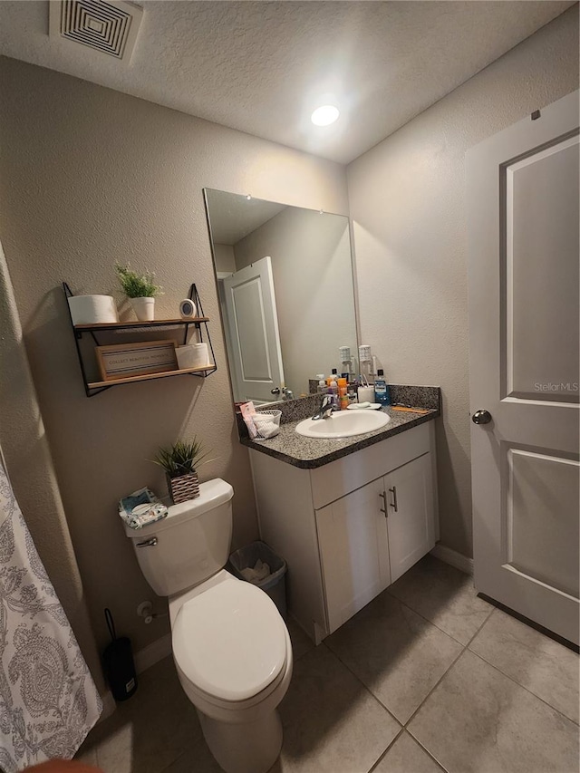 16725 Delia St, Wimauma, FL 33598 - bathroom featuring vanity, tile patterned floors, a textured wall, and a textured ceiling
