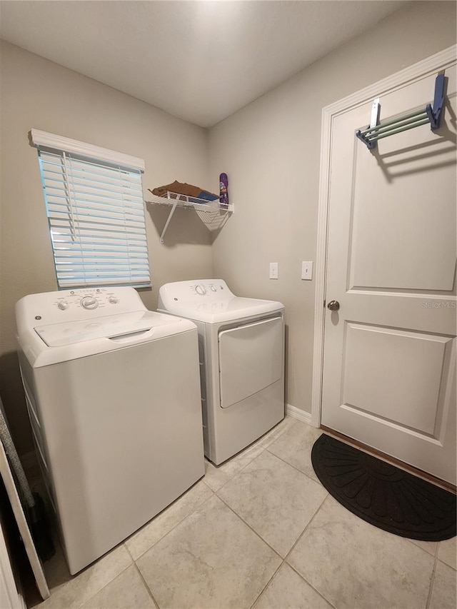 16725 Delia St, Wimauma, FL 33598 - washroom with washer and clothes dryer and light tile patterned floors
