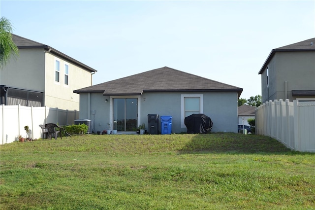 16725 Delia St, Wimauma, FL 33598 - rear view of house with a shingled roof and stucco siding