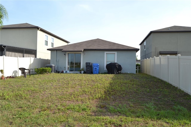16725 Delia St, Wimauma, FL 33598 - rear view of property featuring a fenced backyard, roof with shingles, and stucco siding