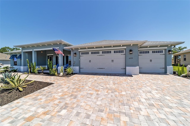 10298 SW 96th Loop, Ocala, FL 34481 - view of front of home featuring decorative driveway, stucco siding, and an attached garage