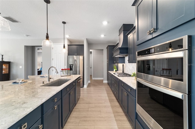 10298 SW 96th Loop, Ocala, FL 34481 - kitchen featuring appliances with stainless steel finishes, a sink, decorative backsplash, custom range hood, and light wood-style floors