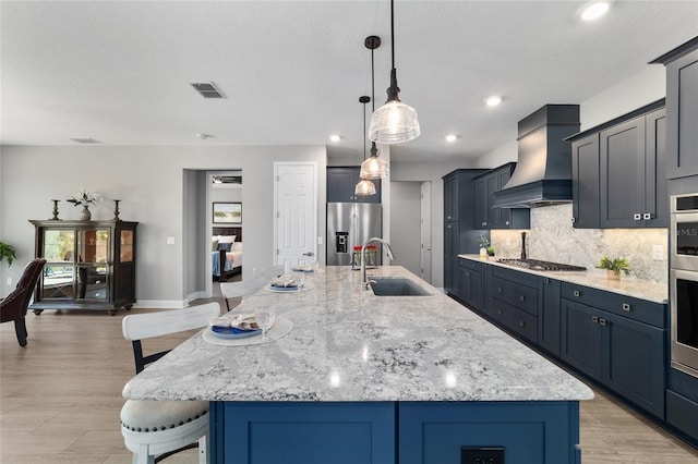 10298 SW 96th Loop, Ocala, FL 34481 - kitchen with premium range hood, a sink, stainless steel appliances, a kitchen breakfast bar, and decorative backsplash