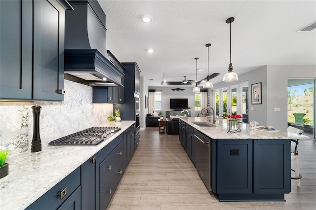 10298 SW 96th Loop, Ocala, FL 34481 - kitchen featuring premium range hood, a sink, appliances with stainless steel finishes, open floor plan, and ceiling fan