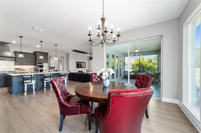 10298 SW 96th Loop, Ocala, FL 34481 - dining space with a chandelier, light wood-style flooring, plenty of natural light, and ceiling fan