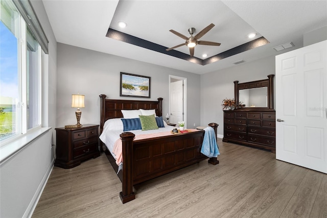 10298 SW 96th Loop, Ocala, FL 34481 - bedroom featuring a raised ceiling, baseboards, light wood-style flooring, recessed lighting, and ceiling fan