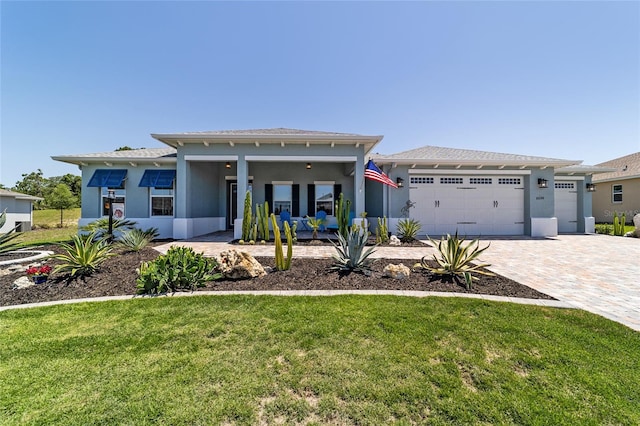 10298 SW 96th Loop, Ocala, FL 34481 - view of front of house with a front yard, a garage, stucco siding, decorative driveway, and a porch