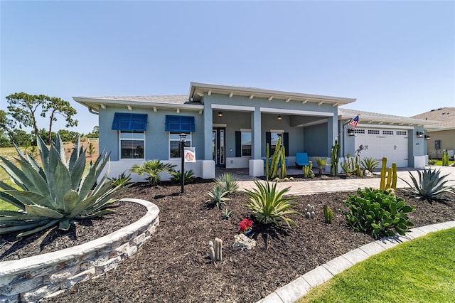 10298 SW 96th Loop, Ocala, FL 34481 - view of front facade with stucco siding, a garage, driveway, and a porch