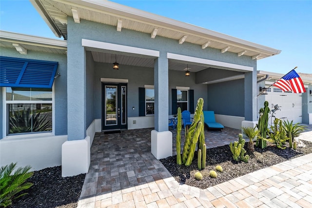 10298 SW 96th Loop, Ocala, FL 34481 - doorway to property with stucco siding and a porch