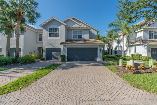 15958 Marcello Cir, Naples, FL 34110 - view of front of property with stucco siding, an attached garage, decorative driveway, and a tiled roof