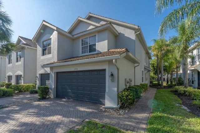15958 Marcello Cir, Naples, FL 34110 - townhome / multi-family property featuring a garage, stucco siding, and decorative driveway