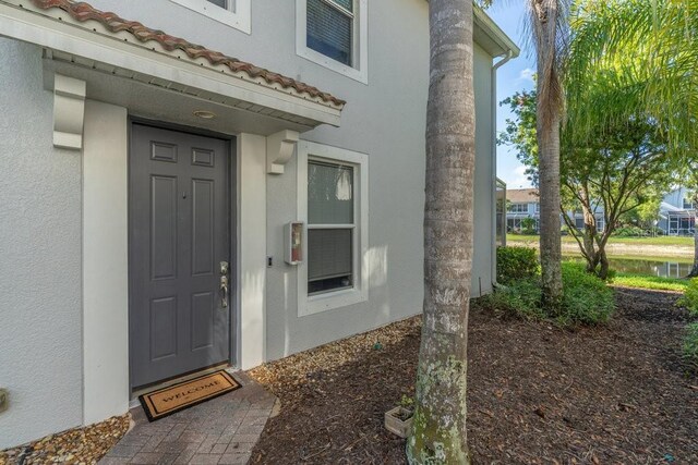 15958 Marcello Cir, Naples, FL 34110 - entrance to property with stucco siding and a tile roof
