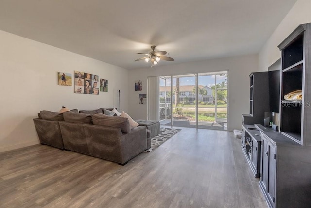15958 Marcello Cir, Naples, FL 34110 - living area featuring wood finished floors, a ceiling fan, and baseboards