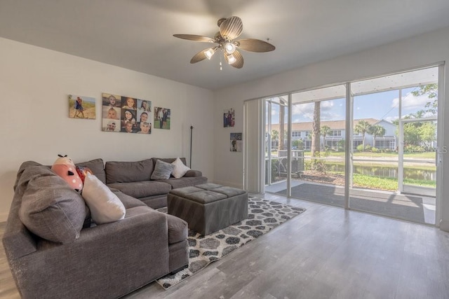 15958 Marcello Cir, Naples, FL 34110 - living area with a ceiling fan, wood finished floors, and a water view