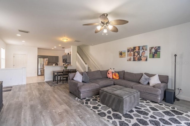 15958 Marcello Cir, Naples, FL 34110 - living room with light wood-type flooring, stairs, a ceiling fan, and recessed lighting
