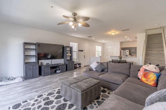 15958 Marcello Cir, Naples, FL 34110 - living room featuring ceiling fan, stairway, and wood finished floors