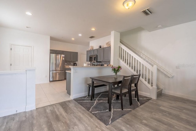 15958 Marcello Cir, Naples, FL 34110 - dining area with light wood-type flooring, stairway, recessed lighting, and baseboards