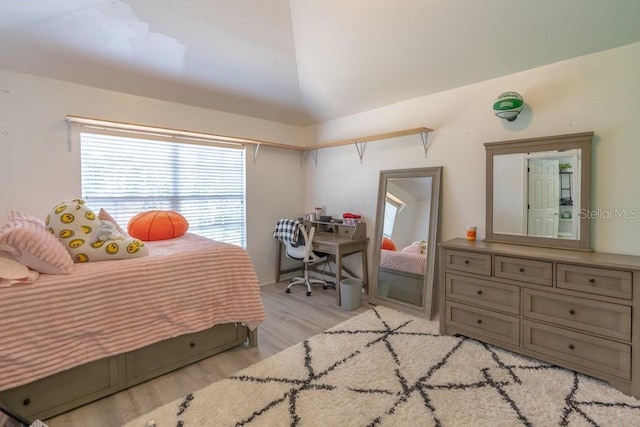 15958 Marcello Cir, Naples, FL 34110 - bedroom with light wood-style flooring and vaulted ceiling