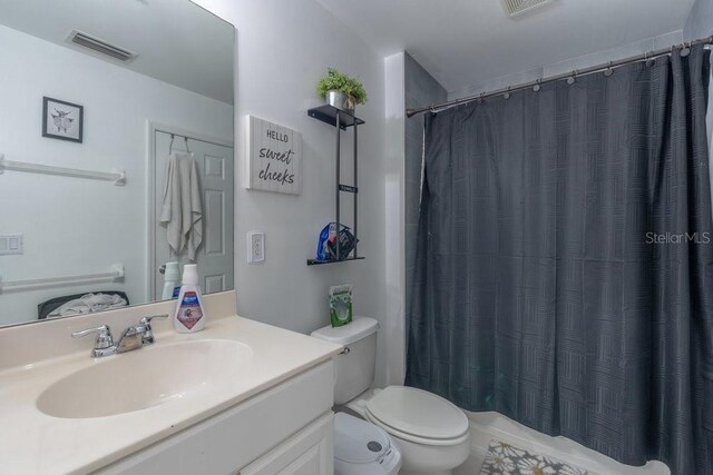 15958 Marcello Cir, Naples, FL 34110 - full bathroom with toilet, vanity, and curtained shower