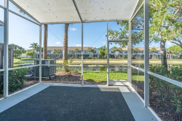 15958 Marcello Cir, Naples, FL 34110 - unfurnished sunroom featuring a water view and a residential view
