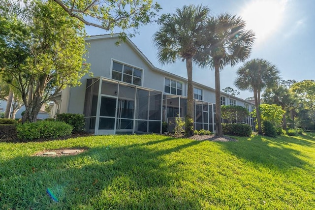 15958 Marcello Cir, Naples, FL 34110 - back of house with stucco siding and a lawn