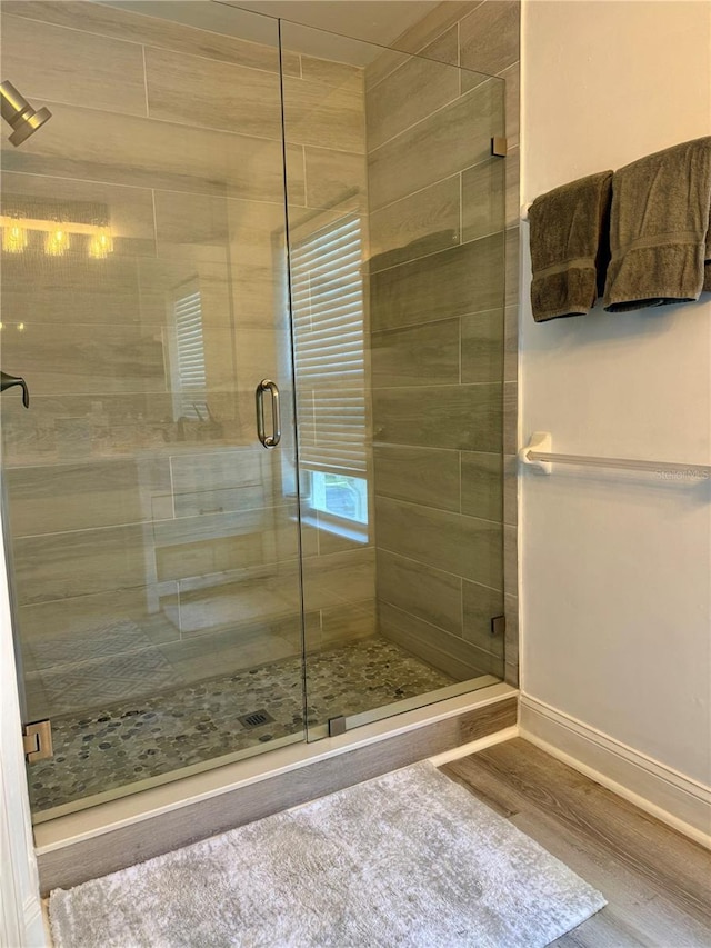 15958 Marcello Cir, Naples, FL 34110 - bathroom with a shower stall, wood finished floors, and baseboards