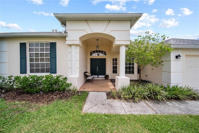 603 Loma Del Sol Dr, Davenport, FL 33896 - entrance to property featuring an attached garage, stucco siding, and french doors