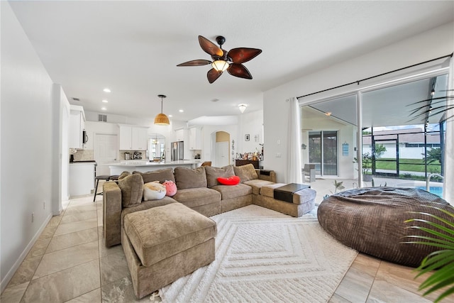 603 Loma Del Sol Dr, Davenport, FL 33896 - living area with arched walkways, a ceiling fan, light tile patterned flooring, and recessed lighting