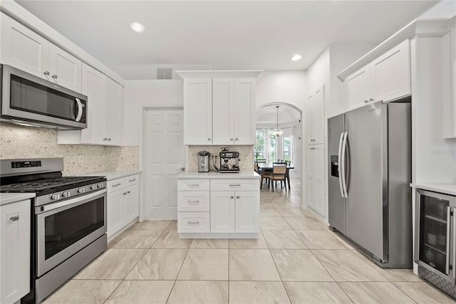 603 Loma Del Sol Dr, Davenport, FL 33896 - kitchen featuring stainless steel appliances, light countertops, beverage cooler, white cabinetry, and recessed lighting