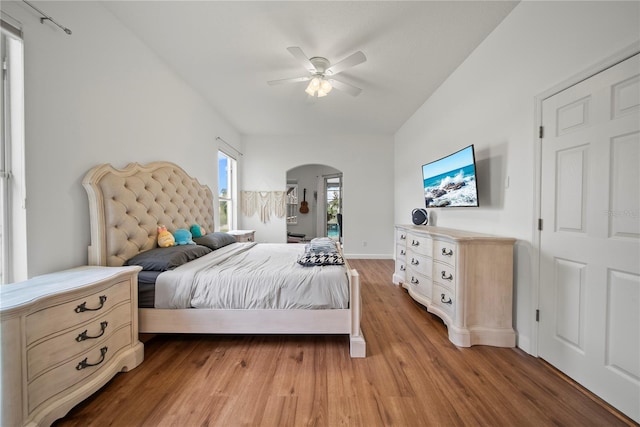 603 Loma Del Sol Dr, Davenport, FL 33896 - bedroom featuring arched walkways, light wood-style floors, and ceiling fan