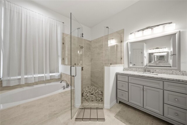 603 Loma Del Sol Dr, Davenport, FL 33896 - bathroom featuring a garden tub, a stall shower, vanity, and tile patterned flooring