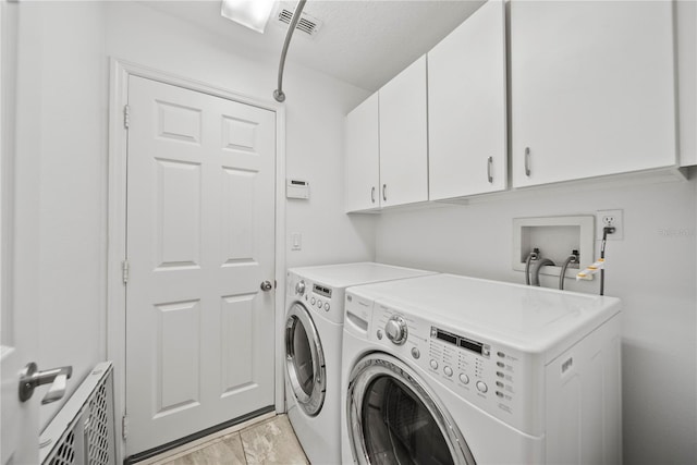 603 Loma Del Sol Dr, Davenport, FL 33896 - laundry room featuring cabinet space, washing machine and dryer, and light marble finish floors