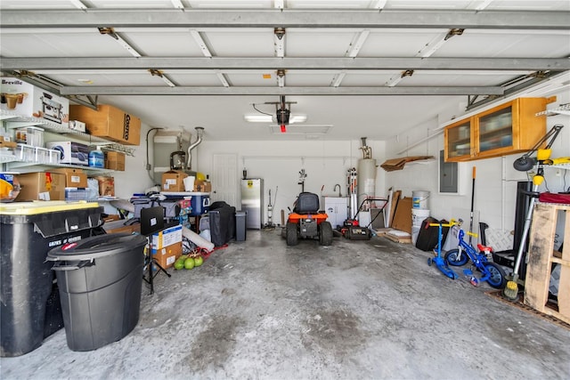 603 Loma Del Sol Dr, Davenport, FL 33896 - garage with freestanding refrigerator, a garage door opener, and water heater