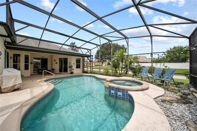 603 Loma Del Sol Dr, Davenport, FL 33896 - view of pool featuring a patio, a pool with connected hot tub, glass enclosure, and area for grilling