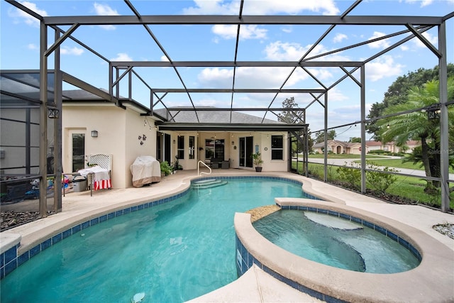 603 Loma Del Sol Dr, Davenport, FL 33896 - view of pool with glass enclosure, a patio, and a pool with connected hot tub