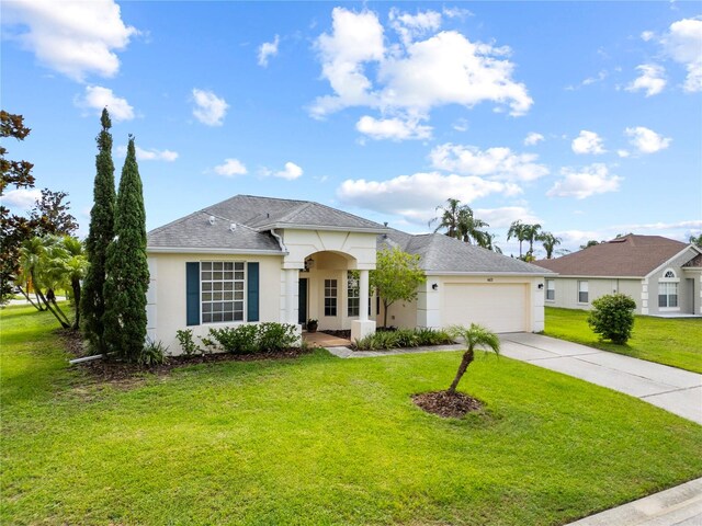 603 Loma Del Sol Dr, Davenport, FL 33896 - single story home featuring stucco siding, an attached garage, concrete driveway, a front yard, and roof with shingles