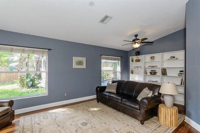 5619 Essex Ct, Palm Harbor, FL 34685 - living area featuring wood finished floors, ceiling fan, baseboards, and lofted ceiling