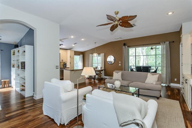 5619 Essex Ct, Palm Harbor, FL 34685 - living room featuring a ceiling fan, dark wood-type flooring, arched walkways, vaulted ceiling, and baseboards