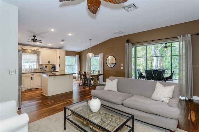 5619 Essex Ct, Palm Harbor, FL 34685 - living room with ceiling fan, dark wood-style flooring, vaulted ceiling, and recessed lighting