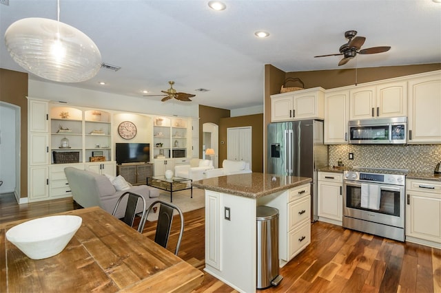 5619 Essex Ct, Palm Harbor, FL 34685 - kitchen featuring stainless steel appliances, a ceiling fan, dark wood-style floors, a kitchen island, and recessed lighting