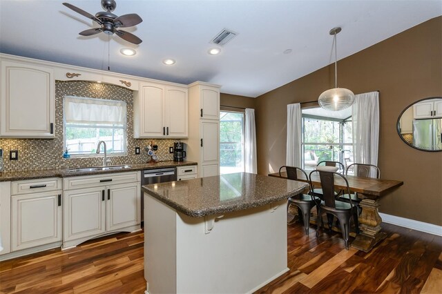 5619 Essex Ct, Palm Harbor, FL 34685 - kitchen featuring a sink, vaulted ceiling, dark wood finished floors, healthy amount of natural light, and recessed lighting