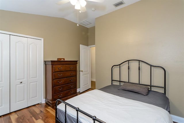 5619 Essex Ct, Palm Harbor, FL 34685 - bedroom featuring a closet, lofted ceiling, wood finished floors, baseboards, and a ceiling fan