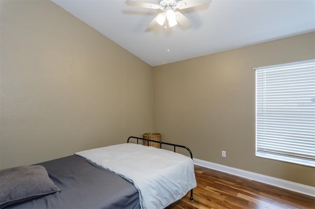 5619 Essex Ct, Palm Harbor, FL 34685 - bedroom with wood finished floors, baseboards, vaulted ceiling, and ceiling fan