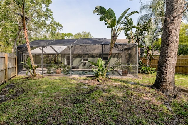 5619 Essex Ct, Palm Harbor, FL 34685 - rear view of property with a swimming pool, a patio area, and glass enclosure