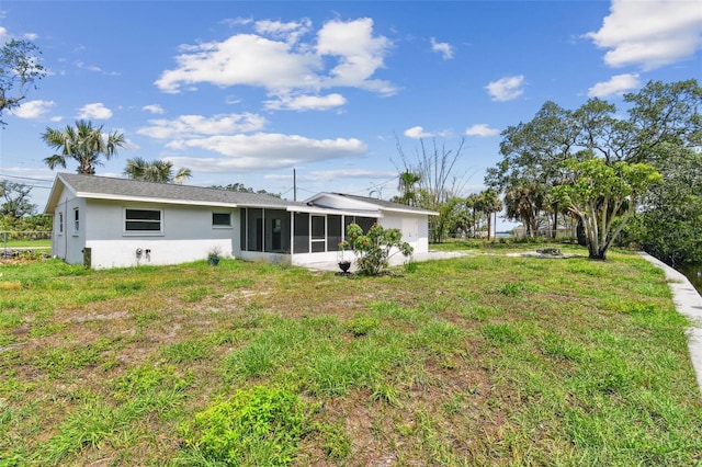 1110 Canal St, Ruskin, FL 33570 - back of property featuring a sunroom, stucco siding, and a garage