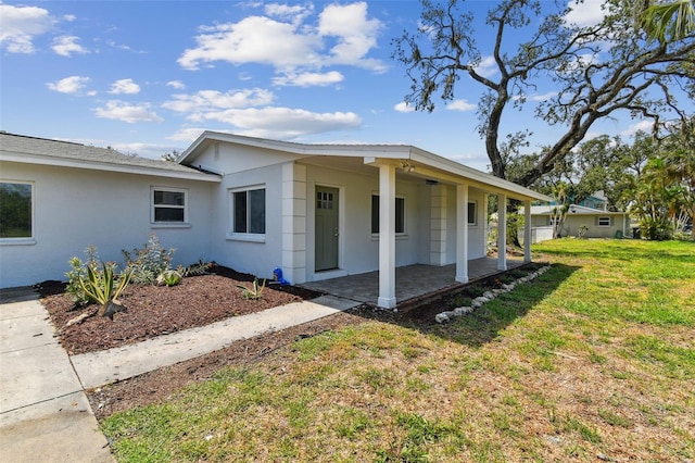 1110 Canal St, Ruskin, FL 33570 - view of front of home with stucco siding and a front yard