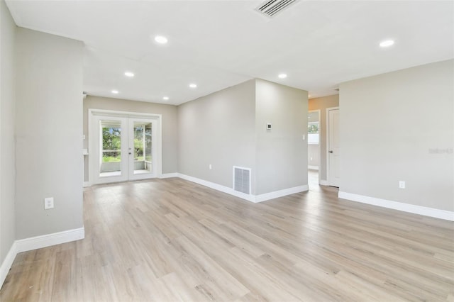 1110 Canal St, Ruskin, FL 33570 - spare room with plenty of natural light, french doors, light wood-style floors, baseboards, and recessed lighting